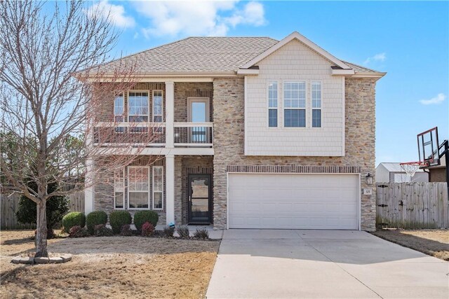 505 Hampton Park Bnd, Cave Springs, AR 72718 - view of front of house with an attached garage, a balcony, fence, driveway, and stone siding