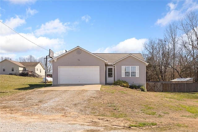 view of front of property with a garage, a front yard, fence, and dirt driveway