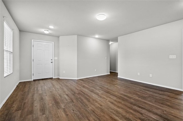 spare room with dark wood-style floors, baseboards, and recessed lighting