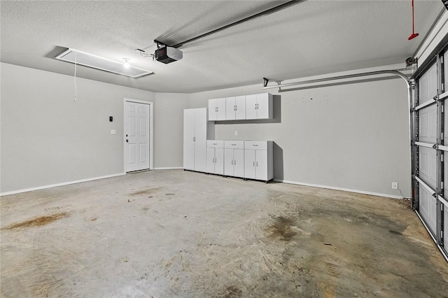 garage with baseboards and a garage door opener