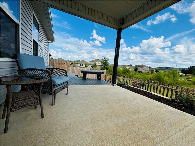 view of patio featuring fence and a deck