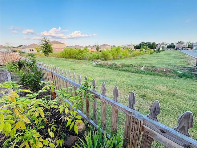 view of yard with a residential view and fence