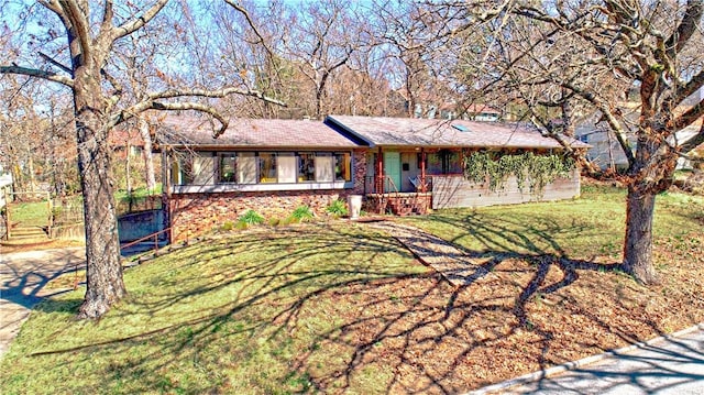 ranch-style house with brick siding and a front yard