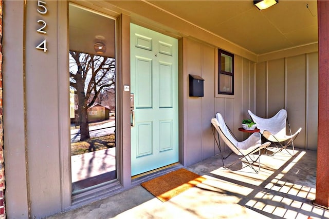 property entrance featuring board and batten siding