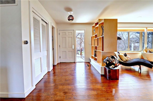 foyer entrance featuring a healthy amount of sunlight, visible vents, and wood-type flooring