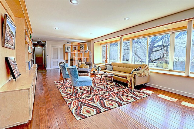 living area with recessed lighting, baseboards, plenty of natural light, and dark wood-style flooring