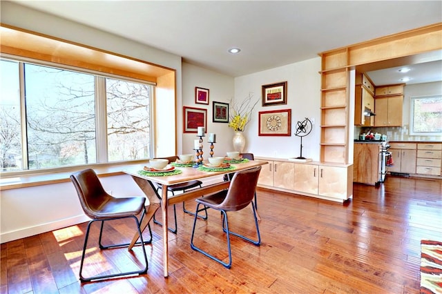 dining space featuring hardwood / wood-style flooring and recessed lighting