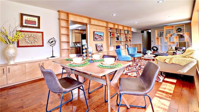 dining room featuring hardwood / wood-style flooring and recessed lighting