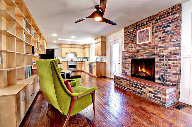 living area with visible vents, recessed lighting, a brick fireplace, ceiling fan, and dark wood-style flooring