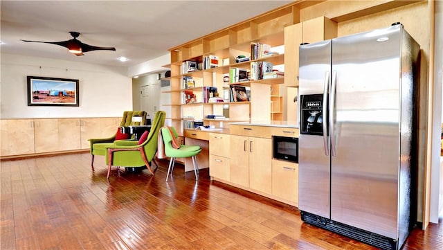 kitchen with light brown cabinetry, stainless steel fridge, a ceiling fan, and hardwood / wood-style flooring