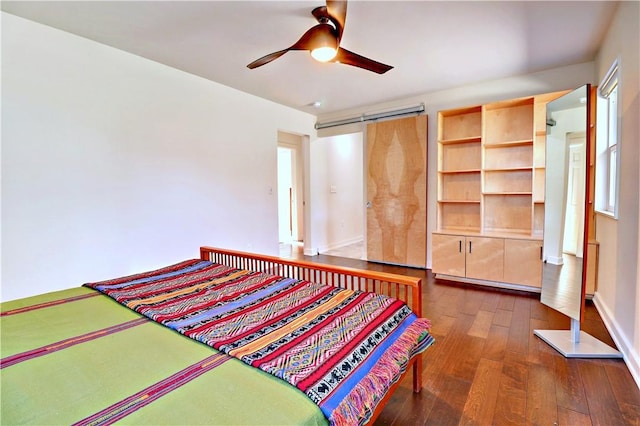 bedroom featuring ceiling fan, dark wood-type flooring, and baseboards