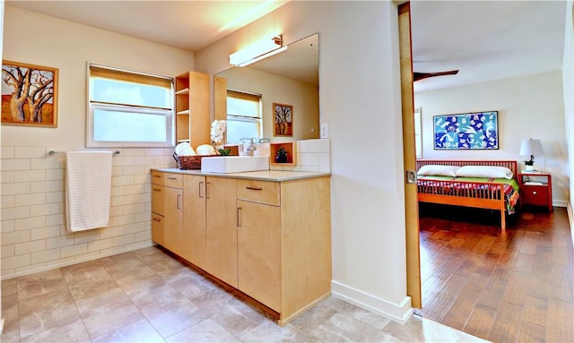 full bath with tile walls, vanity, and ceiling fan