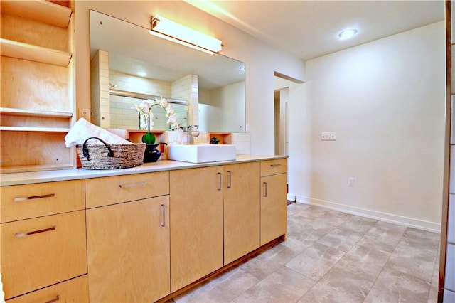 bathroom featuring baseboards, backsplash, a stall shower, and vanity