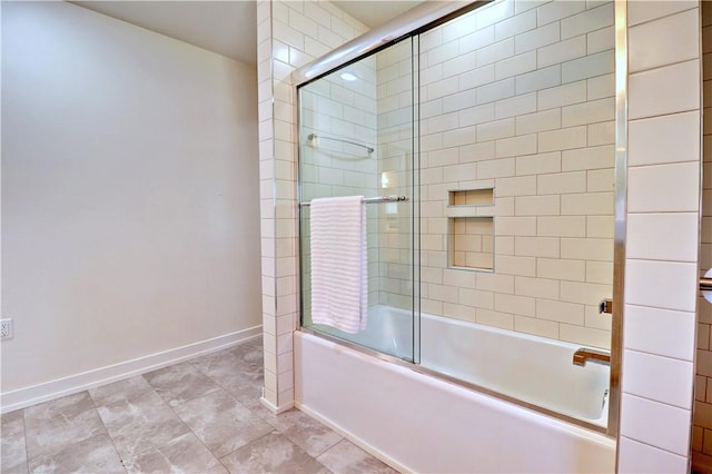 bathroom with baseboards and shower / bath combination with glass door