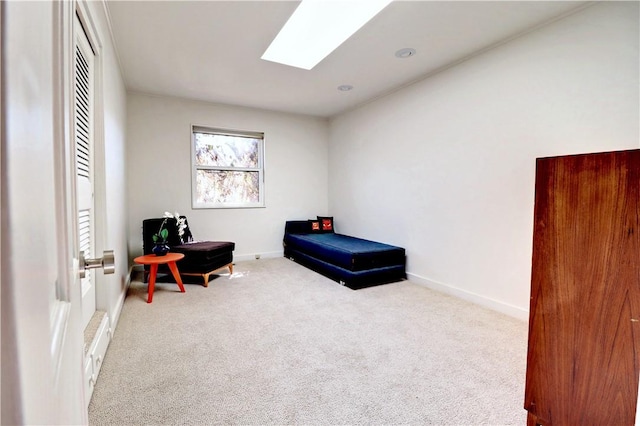 bedroom with a skylight, carpet, and baseboards