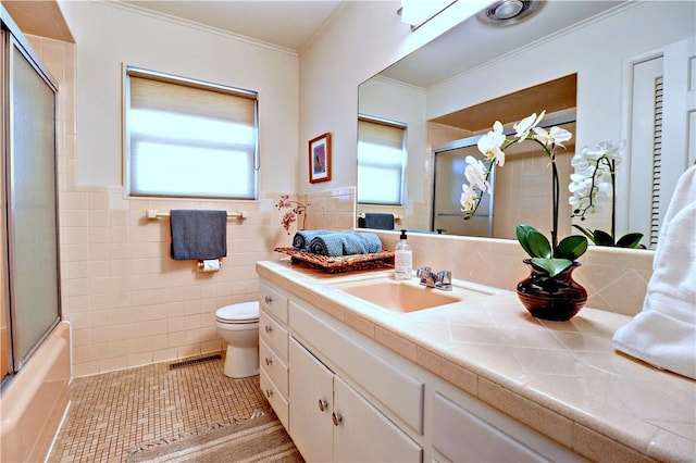 bathroom with tile patterned flooring, tile walls, plenty of natural light, and visible vents