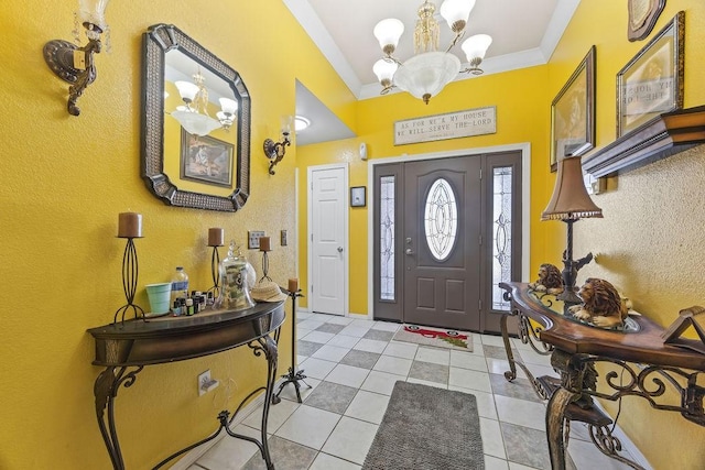 entryway featuring light tile patterned floors, ornamental molding, and a notable chandelier