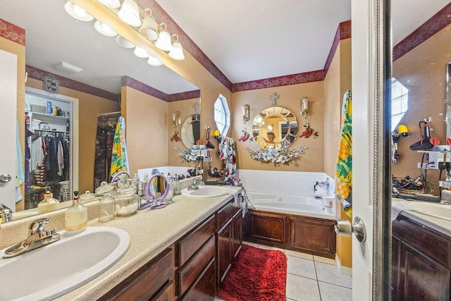 full bathroom with double vanity, a garden tub, a sink, and tile patterned floors