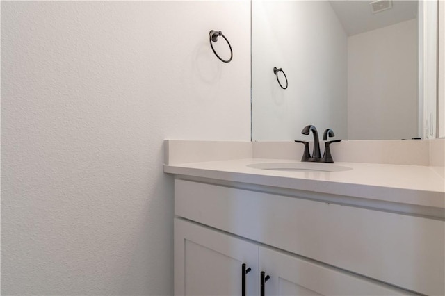 bathroom with visible vents and vanity