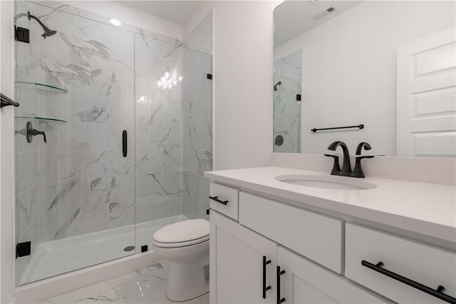 full bathroom featuring toilet, marble finish floor, a marble finish shower, and vanity