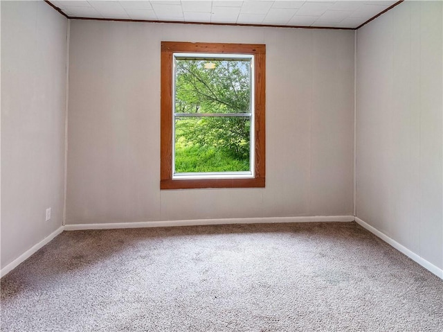 unfurnished room featuring carpet floors and baseboards