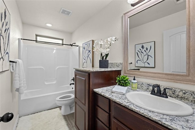 full bathroom featuring toilet, vanity, and shower / washtub combination