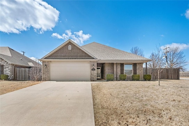 view of front facade with brick siding, a garage, driveway, and fence