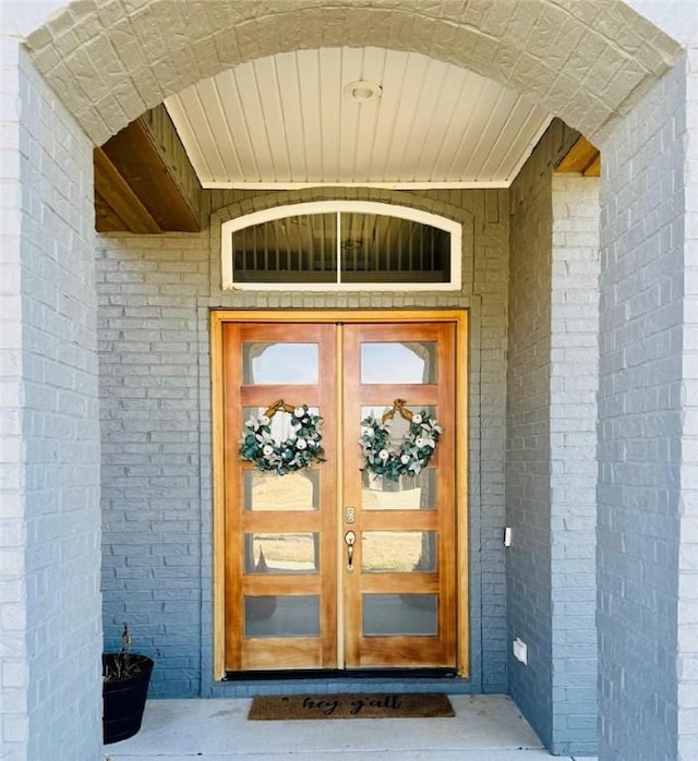 doorway to property with brick siding and french doors