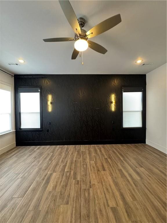 spare room with ceiling fan, baseboards, wood finished floors, and recessed lighting