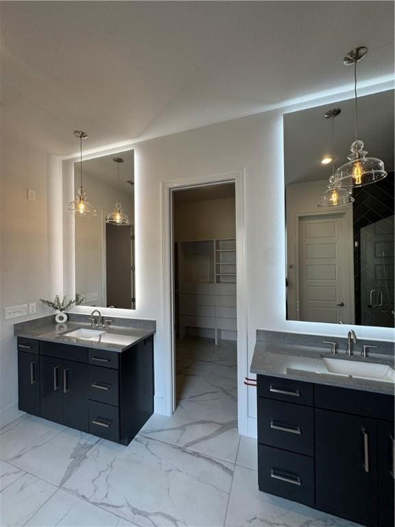 bathroom with marble finish floor, two vanities, and a sink