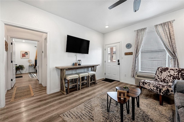 living area with ceiling fan, baseboards, wood finished floors, and recessed lighting