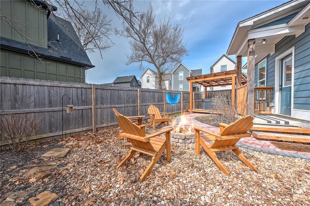 view of yard with an outdoor fire pit, a fenced backyard, and a pergola