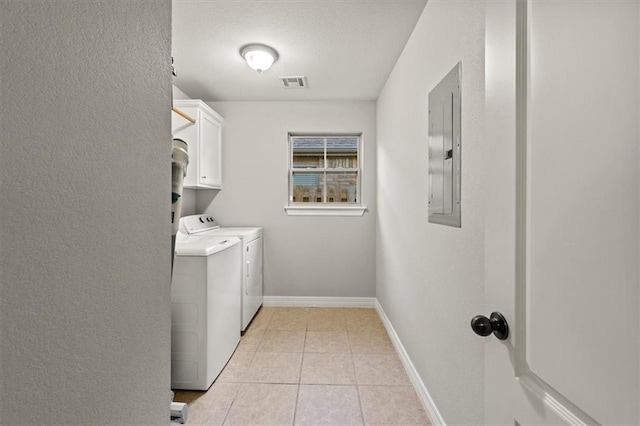 clothes washing area featuring cabinet space, electric panel, visible vents, separate washer and dryer, and light tile patterned flooring