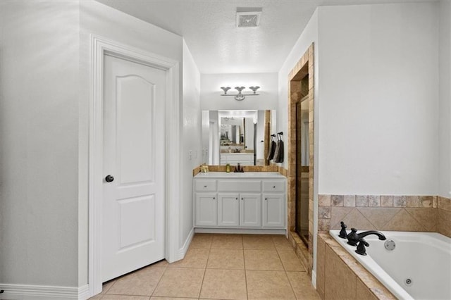 bathroom featuring tile patterned floors, a jetted tub, a textured ceiling, vanity, and a shower stall