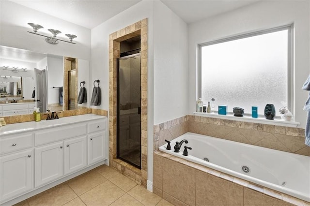 full bathroom with a stall shower, tile patterned flooring, vanity, and a tub with jets