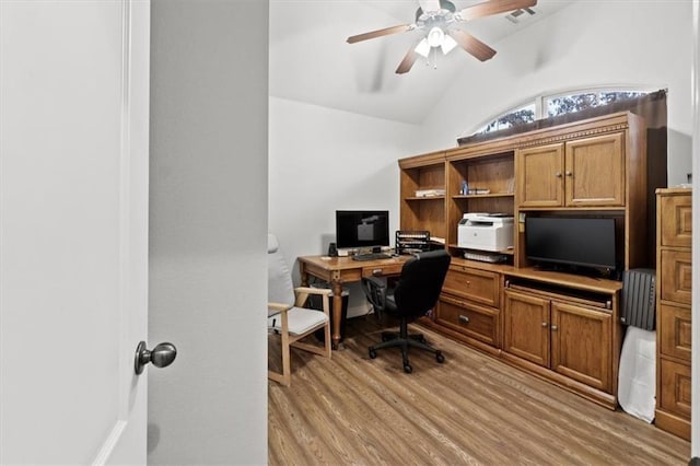 home office featuring a ceiling fan, lofted ceiling, visible vents, and light wood finished floors