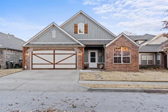 view of front of house featuring concrete driveway, brick siding, and an attached garage