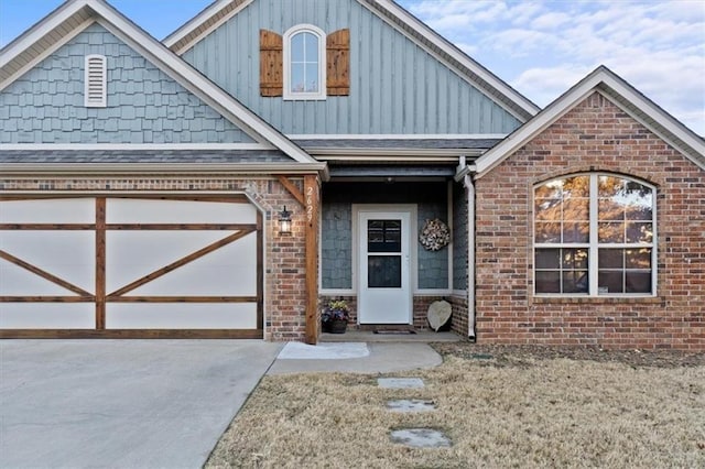 view of front of property featuring board and batten siding, an attached garage, concrete driveway, and brick siding