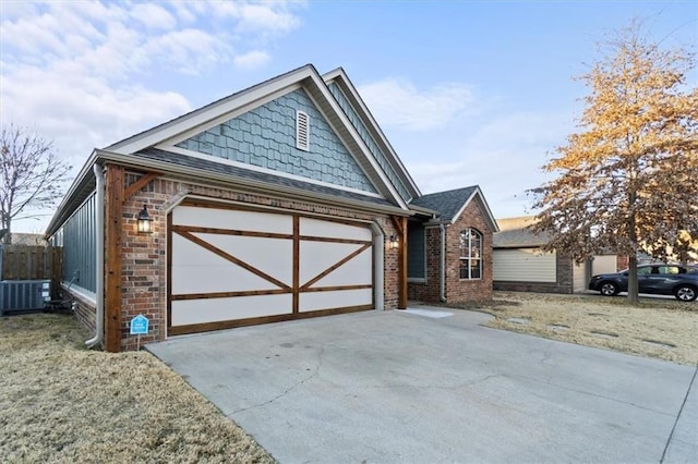 view of front of home featuring driveway, central AC unit, an attached garage, fence, and brick siding