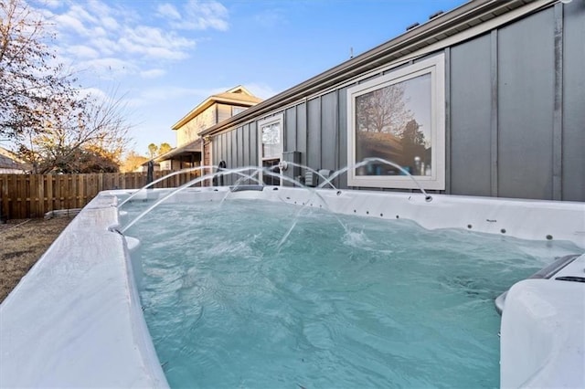 view of swimming pool with fence