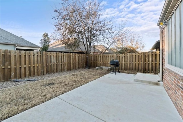 view of patio with a fenced backyard and area for grilling