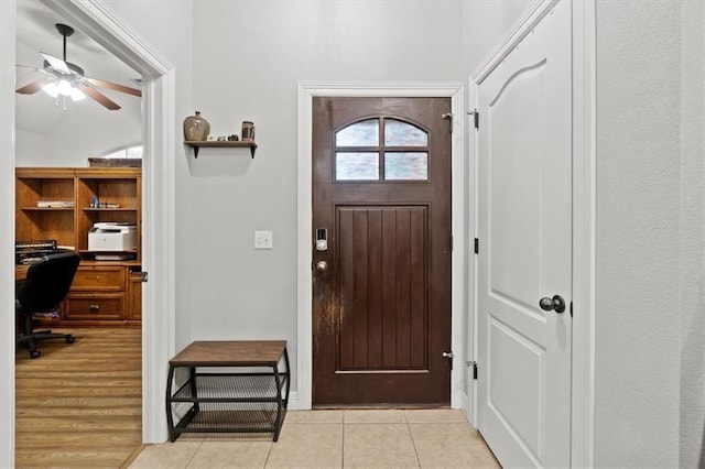 foyer entrance featuring ceiling fan and light tile patterned flooring