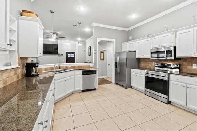 kitchen featuring white cabinetry, stainless steel appliances, a sink, and light tile patterned flooring