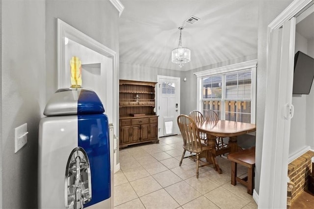 dining space featuring an inviting chandelier, visible vents, and light tile patterned flooring