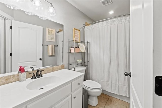 bathroom featuring curtained shower, visible vents, toilet, vanity, and tile patterned flooring