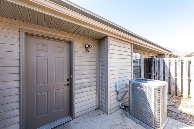 property entrance with central AC and fence