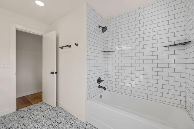 bathroom with tile patterned flooring and washtub / shower combination