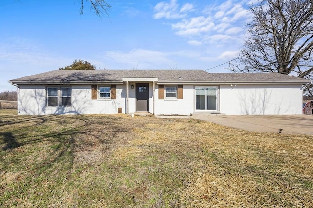 ranch-style home with a patio area and a front lawn