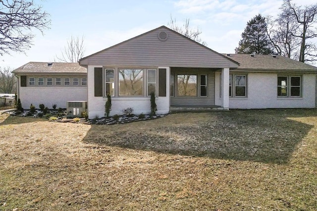 rear view of property with central AC and stucco siding