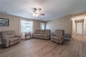 living room featuring ceiling fan and wood finished floors